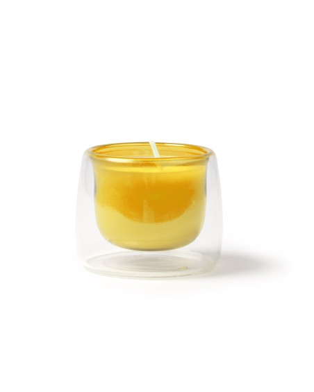 Bougie parfumée à la vanille dans un récipient en verre jaune Bougie parfumée à la vanille dans un récipient en verre jaune