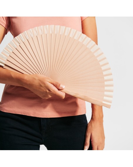 View of a girl using and showing the customizable wooden and cotton fan, ideal for weddings and summer parties